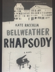 Black and white photo taken of Kindle showing the book cover for The Bellweather Rhapsody by Kate Racculia. Photo taken by Rita E. Gould