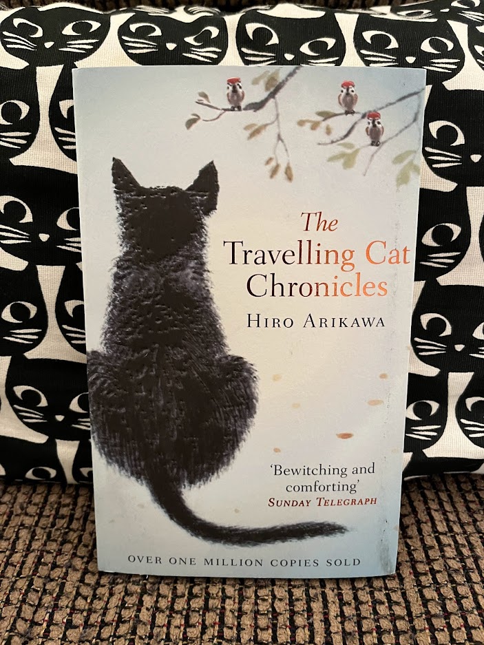 Photograph (taken by Rita E. Gould) of The Traveling Cat Chronicles by Hiro Arikawa (trans. Philip Gabriel).